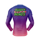 Back view of the long-sleeve Krampus BJJ rash guard, showcasing the same intense gradient design with the stylized Rubber Bones logo wrapped in Christmas greenery, bones, and glowing holiday lights.