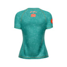 Back of fitted women’s green rash guard with orange stitching and Joe Tamponi x Rubber Bones logo near the collar.