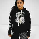 Model wearing the Mat Rat black hoodie, featuring a large hand-drawn rat graphic on the front with the words 'Mat Rat' in bold, graffiti-style lettering. The sleeves display repeating white rat trap illustrations. The hoodie has contrasting cream drawstrings and a relaxed fit, making it a bold statement piece for grapplers.