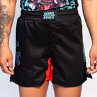 Front view of Rubber Bones Tora Oni BJJ Shorts – Black fight shorts featuring an elastic waistband with Rubber Bones branding and a red stretch gusset.