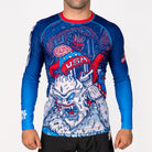 Men's Yeti Games long sleeve rash guard front view featuring skeleton skier choking Yeti artwork in patriotic red, white, and blue, full-length compression sleeves, USA flag patch, red neckline band.