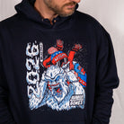 Close-up of navy Yeti Games hoodie showing detailed skeleton skier choking Yeti graphic with patriotic USA red, white, and blue colors and Japanese characters.