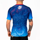 Men's Yeti Games short sleeve rash guard back view showing skeleton skier Yeti design, white Rubber Bones skull logo, red collar band, and compression fit.