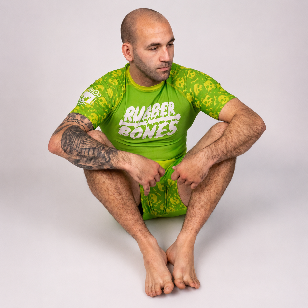 Athlete wearing the Rubber Bones Poison Apple men’s BJJ rash guard and grappling shorts from the Deadly Harvest Collection.