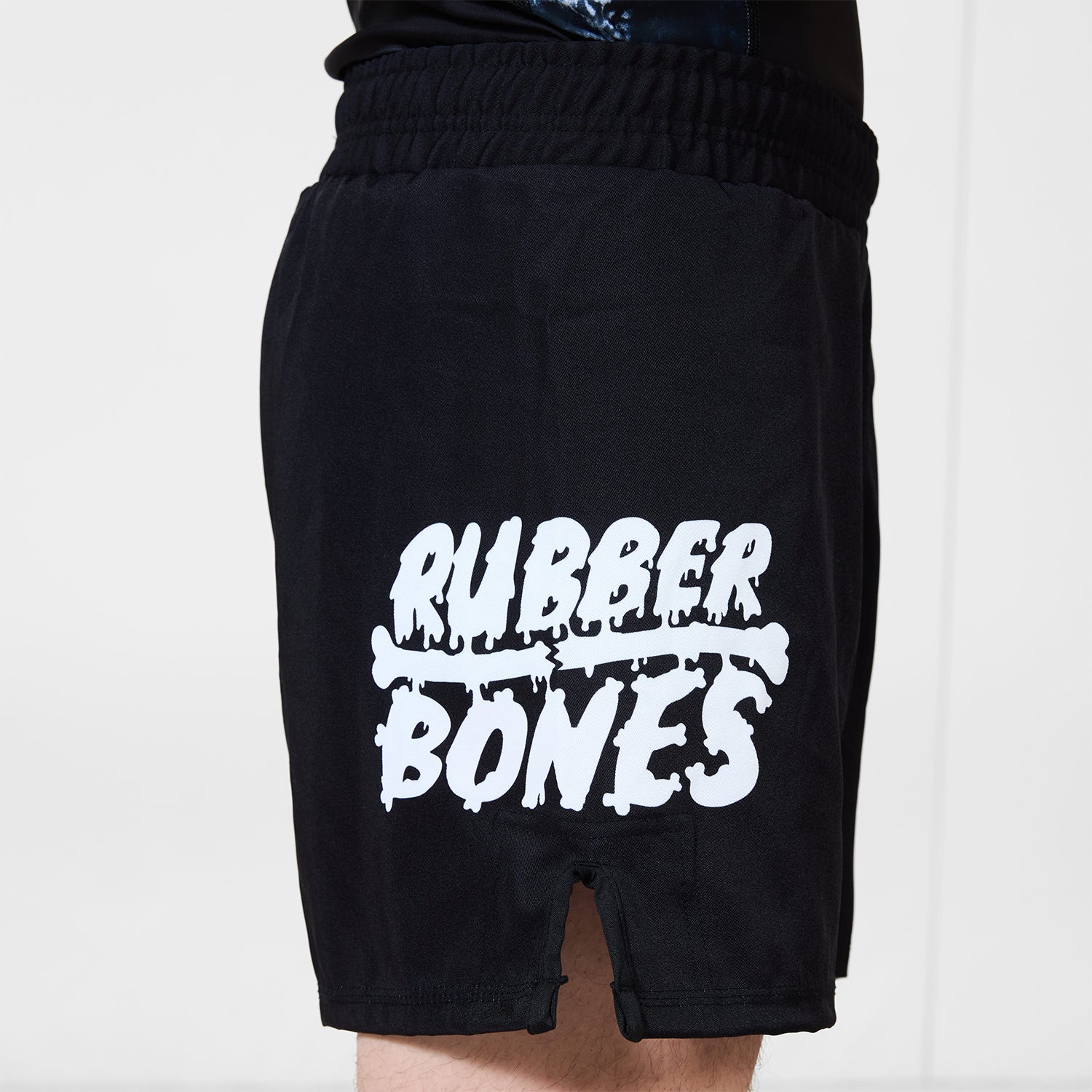 Men’s Ash BJJ Shorts side view with large white Rubber Bones logo printed near hem.