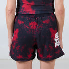 Back view of Men’s Embers BJJ Shorts showing red and black tie-dye pattern with logo details on both sides.