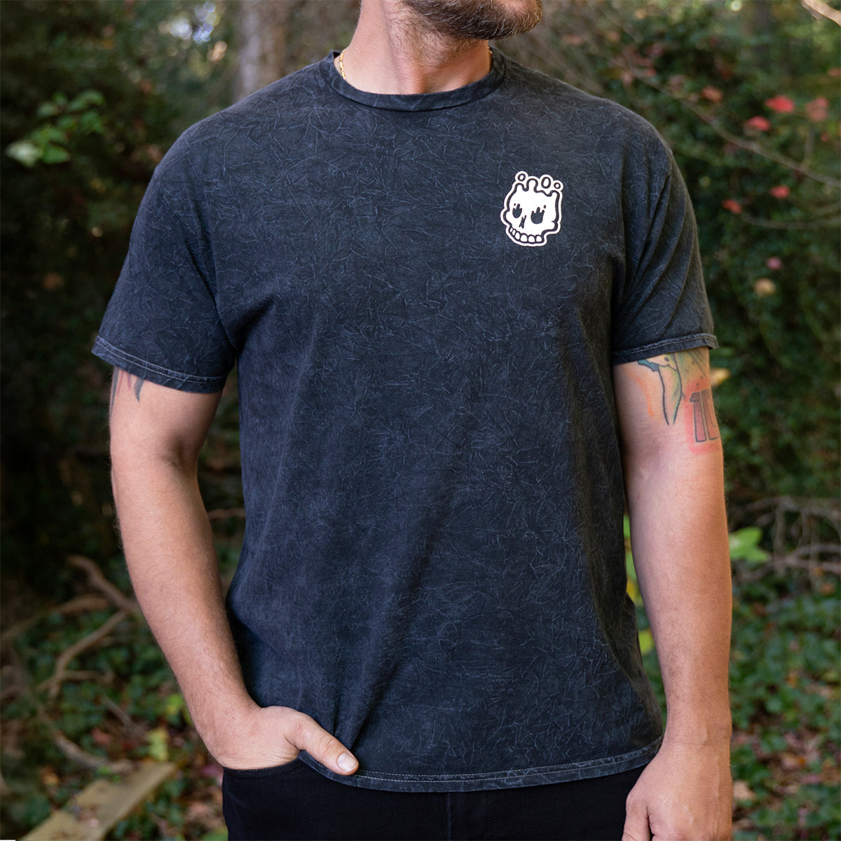 Front view of Rubber Bones Guillotine T-shirt in mineral black with small white skull logo on the chest.