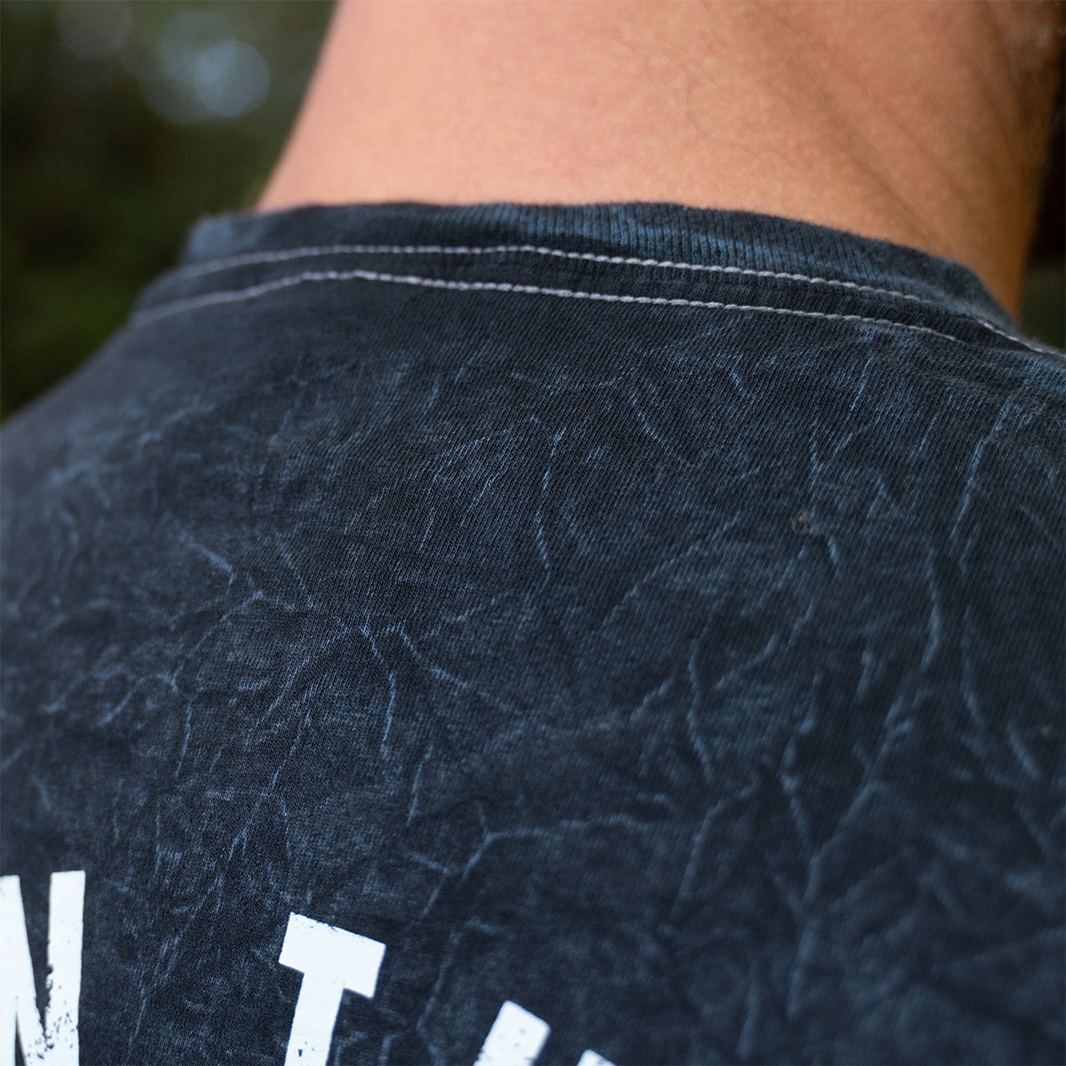 Close-up of neckline and textured mineral wash fabric of the Rubber Bones Guillotine T-shirt.