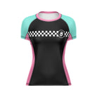 Women’s cut short-sleeve rash guard with a black front panel, teal sleeves, and pink side panels. A white checker stripe crosses the chest, with a small skull logo on the left.