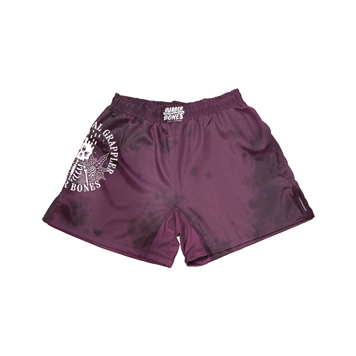 Front View. Maroon no-gi shorts with subtle black tie-dye accents, high-cut sides for mobility, and an elastic waistband with the Rubber Bones logo. Features a bold skeleton illustration and 'Natural Grappler' text on the left leg.