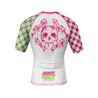 White women’s short-sleeve BJJ rash guard featuring a large pink dripping skull and crossbones graphic on the back. Sleeves are split with green and pink skull patterns, and 'Rubber Bones Rash Guards' branding is printed at the lower back.