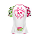 White women’s short-sleeve BJJ rash guard featuring a large pink dripping skull and crossbones graphic on the back. Sleeves are split with green and pink skull patterns, and 'Rubber Bones Rash Guards' branding is printed at the lower back.