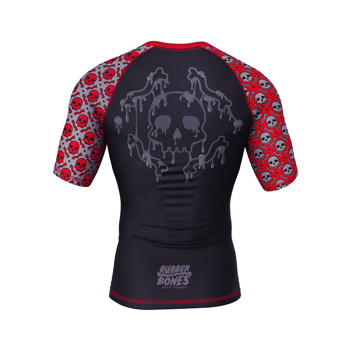 Black rash guard with red sleeves featuring an all-over pattern of small skulls. The back displays a large, dripping skull design in a ghostly gray, with "Rubber Bones Rash Guards" subtly printed near the lower back.