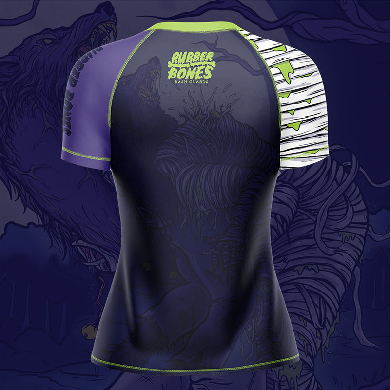 Women's Full Moon BJJ Rash Guard mock-up, back view, showcasing werewolf-themed artwork in vibrant blue, purple, and green hues.