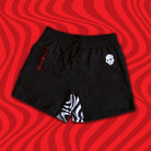 Mock-up of Kids Skullwave Grappling Shorts featuring bold skull-inspired design with black and red accents, front view.