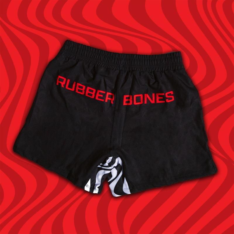 Mock-up of Kids Skullwave Grappling Shorts showcasing red Rubber Bones logo with sleek design, back view.