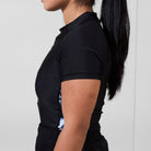 Side profile of the Women’s Ash BJJ Rash Guard showing black fabric and gray marble print panels.