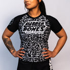 Front view of the Rubber Bones Ranked Black BJJ rash guard – Black short-sleeve rash guard with a white skull pattern and Rubber Bones logo on the chest.